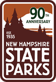 A logo for New Hampshire State Parks 90th anniversary features tall pine trees, mountains, EST. 1935, and bold text reading NEW HAMPSHIRE STATE PARKS on a brown and white background.