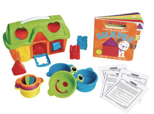 Colorful educational toys, including a shape sorter house, stacking cups, a frog-shaped container, and a “Carry and Learn: Shapes” book, along with printed activity sheets, all arranged on a white background.